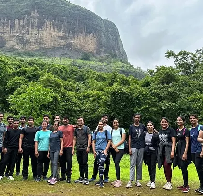 The group at the start of the Devkund Waterfall trek, with the unique landscape of the region behind them.