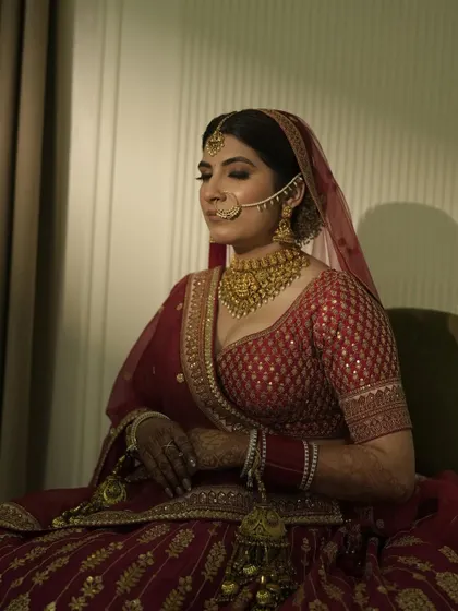 It was so special getting my own sister ready for her big day. Here she is, looking serene and beautiful in her classic red lehenga with timeless gold jewelry.