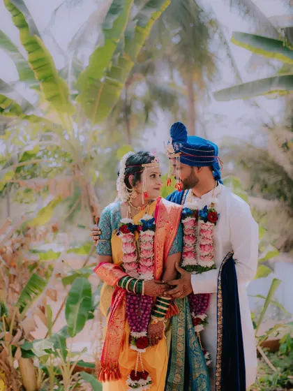 A romantic portrait of the couple amidst a backdrop of lush palm trees.