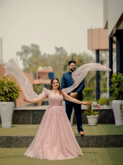 A playful and dynamic shot of the couple. Mansi's veil flows in the wind, adding a sense of movement and joy to this beautiful outdoor portrait.