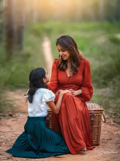 A mother placing a flower in her daughter's hair is such a tender, timeless gesture. It’s these small, loving interactions that create the most powerful and lasting memories.