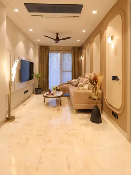 A full view of the completed family lounge, where warm lighting and a sleek TV panel create a perfect space for family time.