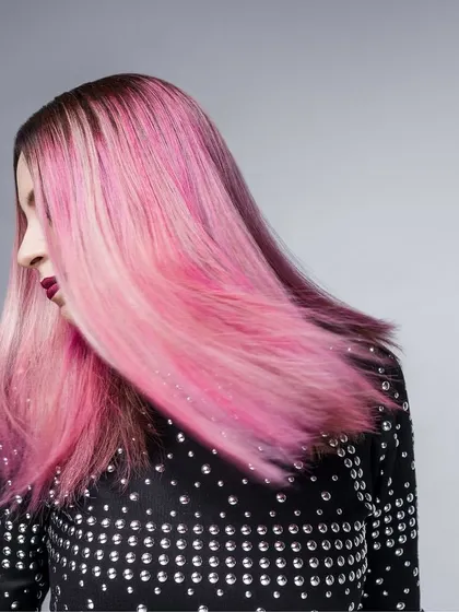 A dynamic shot of musician Bianca Gomes, where the styling is all about attitude. A studded black mesh top is paired with her signature pink hair, capturing movement and her rockstar persona.