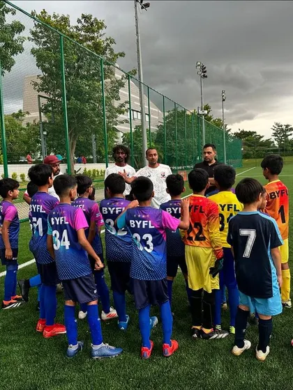 A coach giving a team talk to our youngest players, explaining a drill and motivating them.