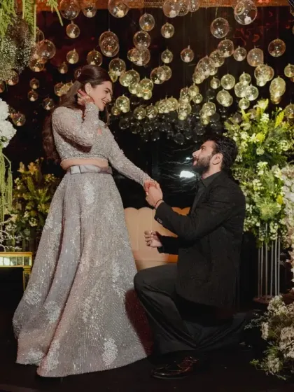 A romantic proposal during an engagement ceremony, set within a lush floral grotto. We design intimate yet stunning backdrops for life's most precious questions.