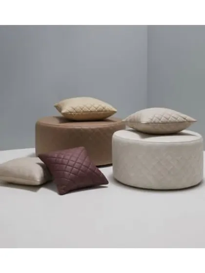 This contemporary quilted fabric offers a clean, modern, and luxurious feel. It's perfect for creating minimalist yet comfortable ottomans and cushions, as seen in this neutral-toned setting.