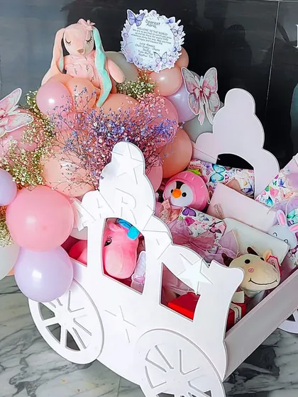 Another view of the magnificent pink chariot hamper, showcasing its scale and the abundance of gifts and decorations it holds.