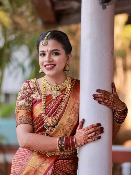 This shot showcases the bride's beautiful smile and the flawless application of her makeup.