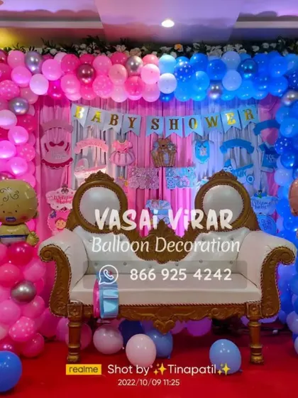 For a larger baby shower celebration, I can create a grand stage setup. This one features a wide backdrop of pink and blue balloons, a "Baby Shower" banner, and elegant white chairs for the parents-to-be.