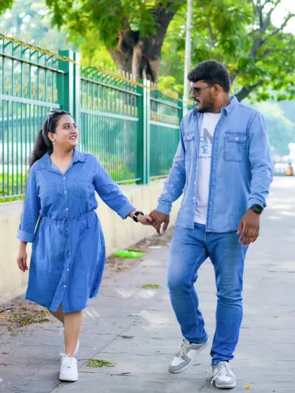 A candid walking shot, capturing a sweet, shared moment during an urban pre-wedding photoshoot.