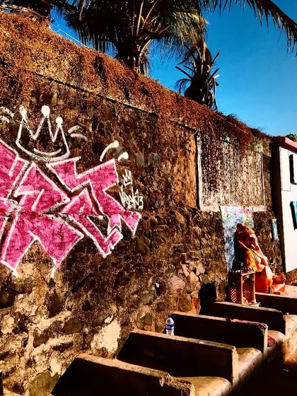 Another angle of the Versova graffiti, with a Ganesha statue adding an unexpected, beautiful contrast. This is the magic of street art in India.
