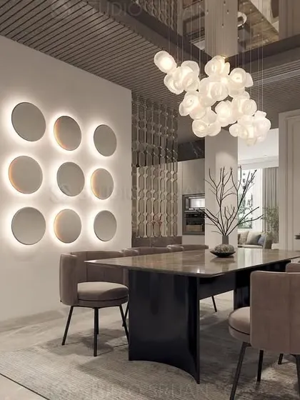 The dining space in the DLF residence, featuring a stunning cluster of pendant lights over the table and a backlit wall of circular mirrors that doubles as a piece of art.
