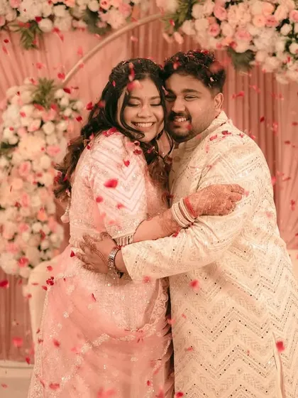 A heartfelt embrace after a successful proposal, surrounded by a sea of flower petals.