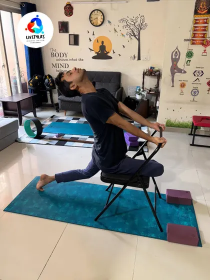 A client uses a yoga chair for a supported lunge, which allows for a deeper stretch in the hip flexors and quadriceps while maintaining balance and stability.