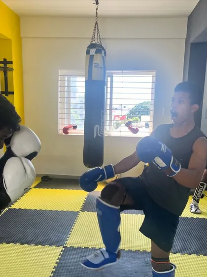 A young fighter practices his knee strikes during a kickboxing drill. We teach a full range of striking techniques for well-rounded fighters.