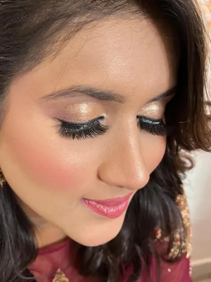 A glamorous party look with dramatic lashes and shimmery gold eyeshadow.