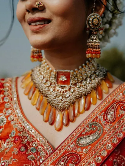 An extreme close-up on the stunning bridal jewelry. This shot highlights the craftsmanship of the necklace and earrings, details that are so important to the overall look.