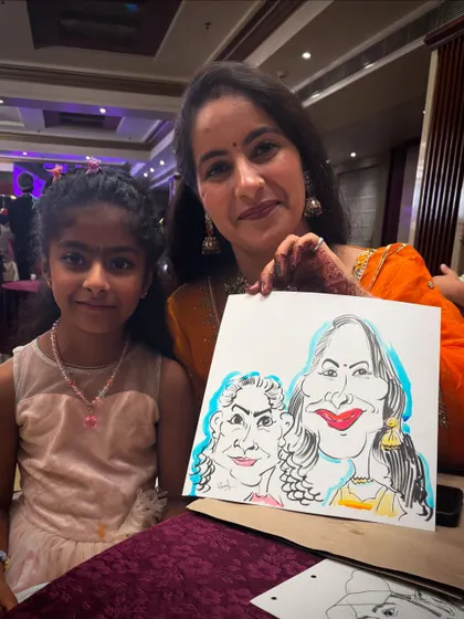 Another beautiful duo with their caricature, capturing a moment of family fun.