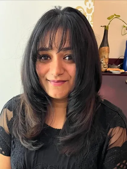 Bangs and face-framing layers for Priyanka.