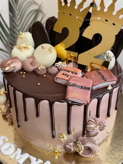 A slice of story and a chapter of sweetness. This chocolate drip cake was designed for a 22nd birthday, complete with crowns and favorite book titles.