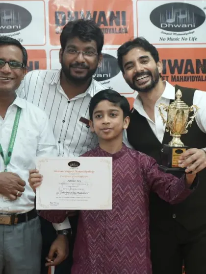 A student receives his grand trophy from our team of dedicated teachers.