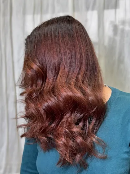 The "after" shot, showing the rich, healthy, and beautifully toned brown hair. The color correction completely revived the hair, giving it depth and shine.