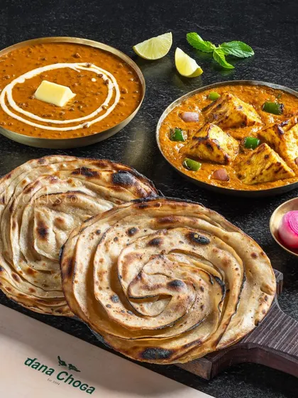 A classic North Indian meal of Dal Makhani, Paneer Tikka Masala, and Lachha Parathas.