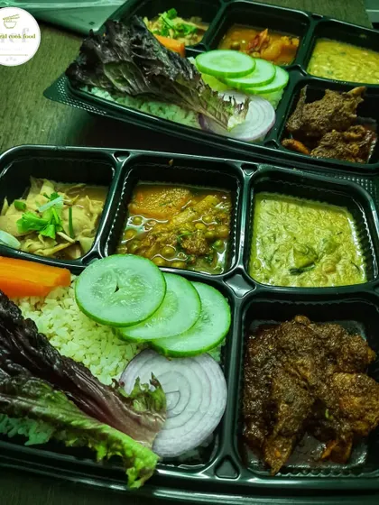 An evening snapshot of my chicken thali, packed and ready to go. It includes rice, salad, and a selection of veg and non-veg side dishes.