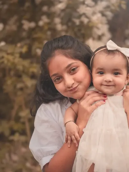 A happy smile from the baby makes this sibling portrait extra special. The genuine connection and joy between them is what I strive to capture.