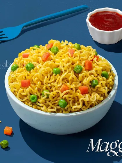 A bowl of Maggi noodles with peas and carrots, a beloved Indian comfort food, styled with a minimalist aesthetic.