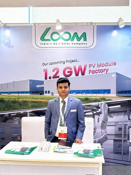 Our representative at the Gujarat expo, standing proud before a backdrop showcasing our massive upcoming PV Module Factory, a key part of our growth strategy.