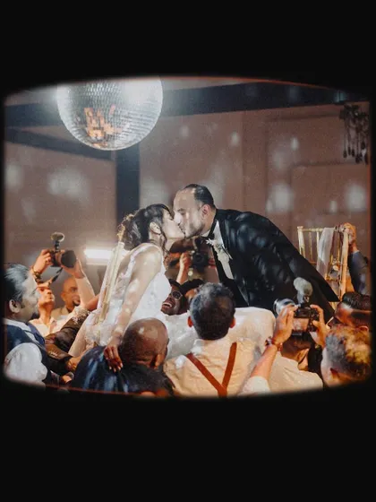 A unique, artistic shot of the couple's kiss, framed as if seen through a vintage viewfinder. This creative approach highlights our fine art and cinematic style.