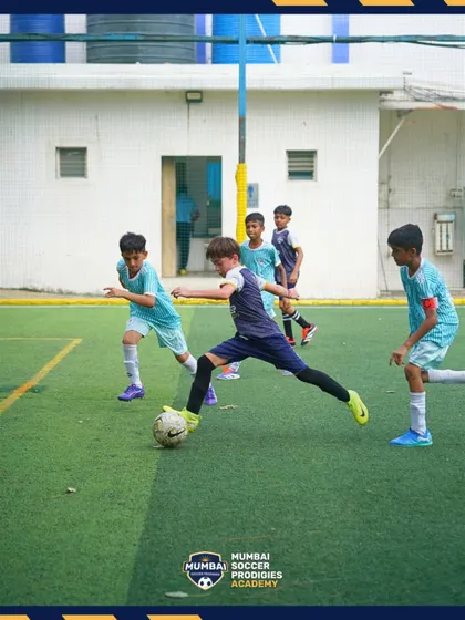A player stretches to control the ball, showcasing agility and commitment.