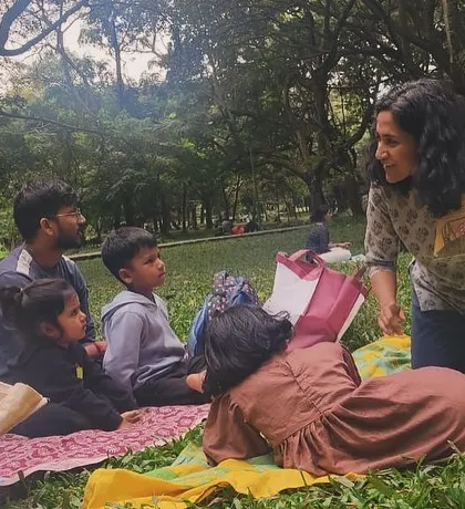 A wider perspective of our story circle, showing how we fit into the larger, vibrant atmosphere of Cubbon Park on a Saturday.