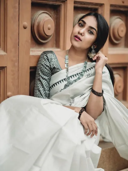 This seated pose offers a different perspective, highlighting the blouse design and the way the fabric settles. It’s a great shot for showcasing jewelry pairings.