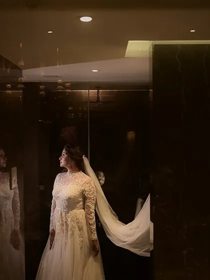 A dramatic and artistic shot of the bride and her flowing veil. The makeup looks stunning even in low light.
