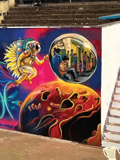 A detailed section of the IIT Bombay mural, featuring an astronaut floating through a cosmic landscape. This piece explores the idea of venturing into the unknown to achieve your dreams.
