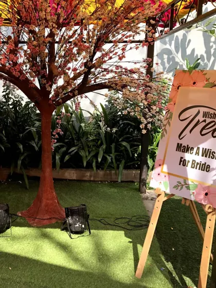 A 'Wish Tree' is a wonderful way to involve guests. We set up this tree and sign so guests could write their wishes for the bride and hang them on the branches, creating a beautiful collective blessing.