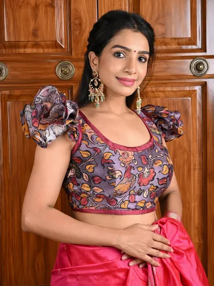 Statement chandbali earrings are the perfect accessory for this puff-sleeved, printed blouse, creating a bold and stylish look.
