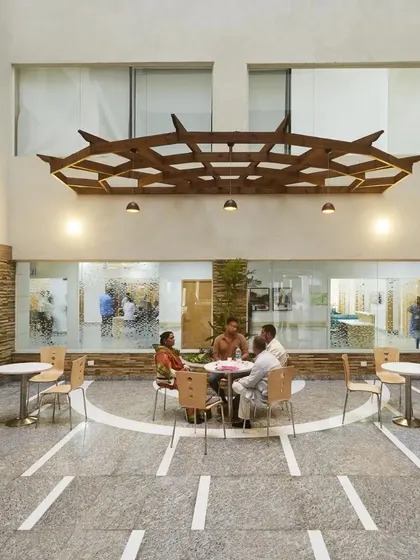 The central atrium of this healthcare facility is a light-filled, serene oasis. Designed with comfortable seating and an uncluttered layout, it provides a calming environment and makes navigation easy for visitors.