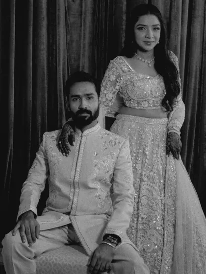 A stylish black and white portrait of the couple, exuding elegance and confidence.