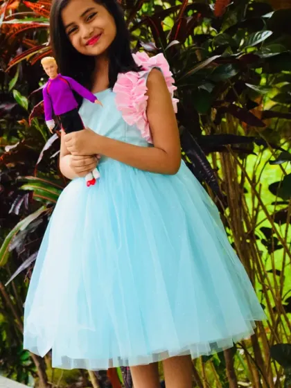 Even her doll gets to be part of the fun. My client posing with her Barbie in her custom-made birthday dress.