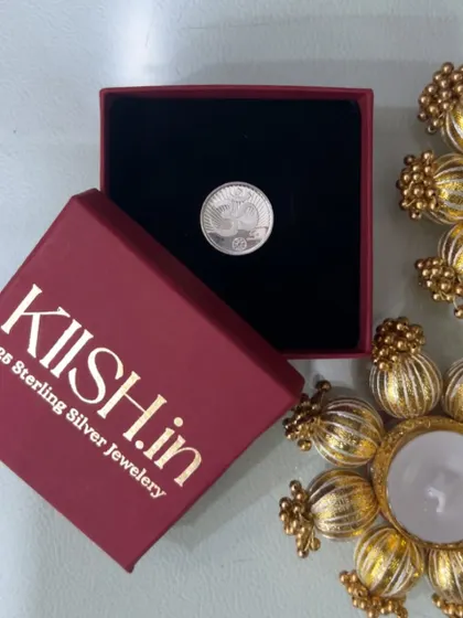For Ganesh Chaturthi, I curated this special gift box featuring a sterling silver coin from Kiish, paired with beautiful marigold-themed diya holders.