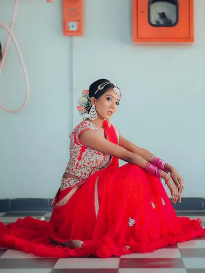 Another variation of the seated pose, showing the full spread of the red lehenga. The repetition of this series shows my ability to capture a variety of shots for a single look.