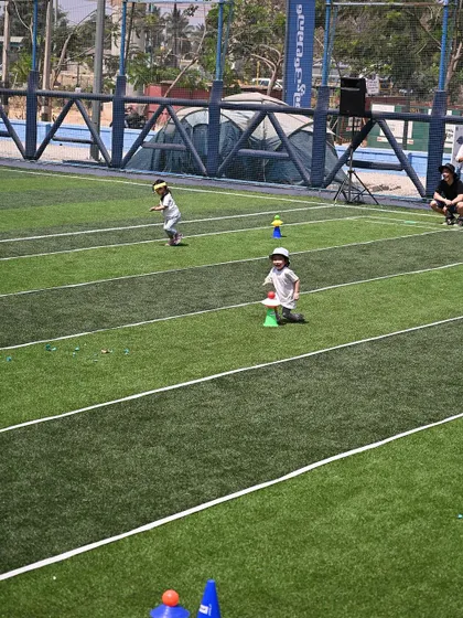 Two children race across the field during one of the sports day events.