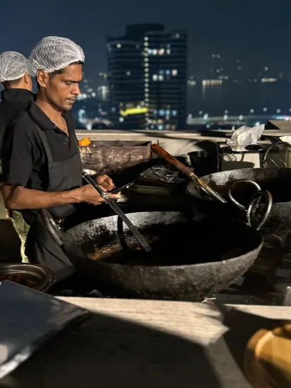 My chef expertly managing the kadai at a rooftop Diwali party. This live station for frying appetizers ensures that every bite is crispy, hot, and absolutely fresh.