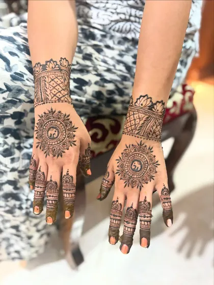 A matching set of back-hand designs with elephant mandalas. This is a great option for guests at a wedding or for a festive occasion.