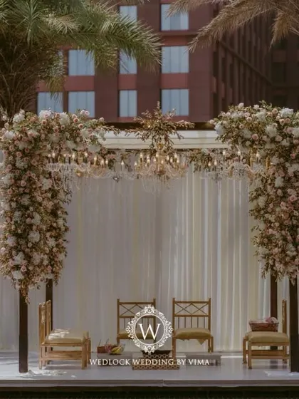 For this Punjabi wedding, we designed a subtle and elegant poolside mandap. The decor featured light fabrics, soft peachy-pink florals, and hints of gold to complement the serene setting.