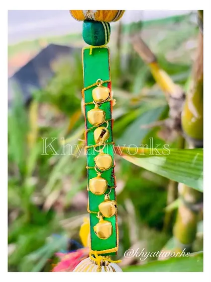 A detail shot of the side of the kite hanging, showing the little ghungroos wrapped around the frame. It’s all about adding texture and sound.