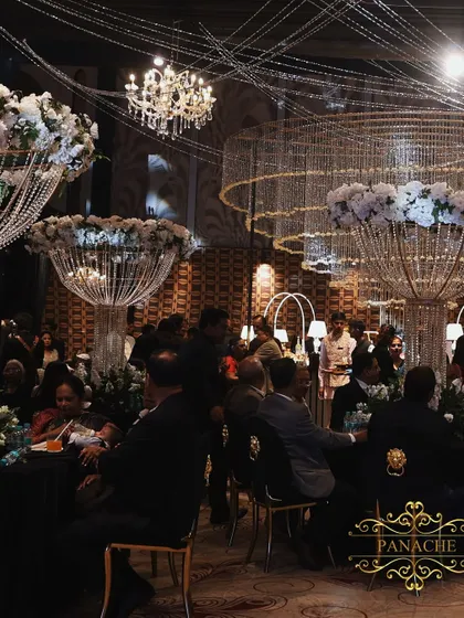 A Sangeet night designed for modern royalty, where dramatic crystal chandeliers float above a chic black and white setting. This showcases our ability to blend contemporary glamour with timeless luxury for an unforgettable party atmosphere.